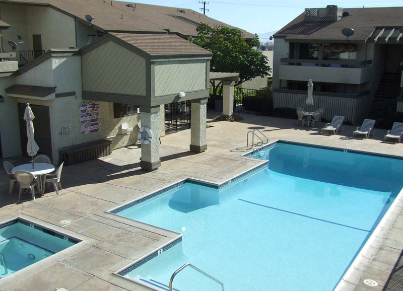 a swimming pool and a spa in front of a hotel